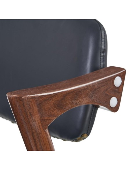 Silla FONDES de metal con acabado nogal y cuero sintético negro.